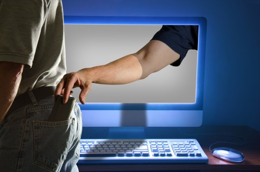 hand coming out of the computer screen stealing a man's wallet from back pocket, identity theft, id watchdog